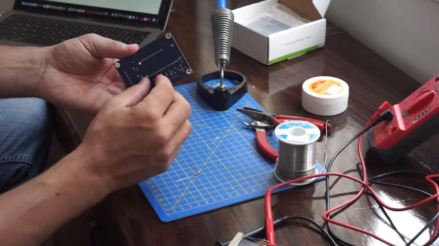 Hand-assembling a Theia circuit board at a soldering bench