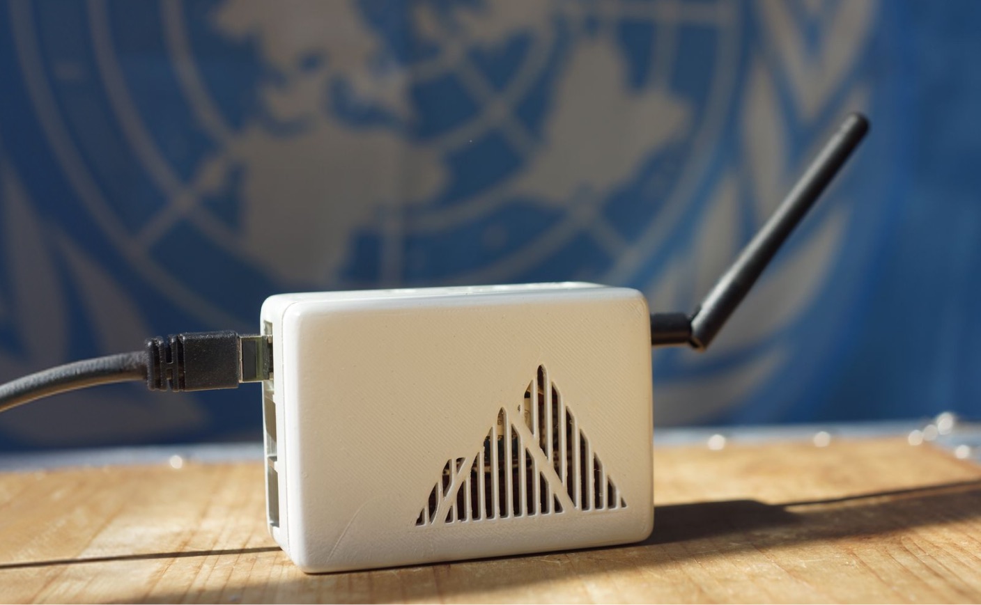 The Theia Hub with its LoRa antenna, in front of a United Nations flag